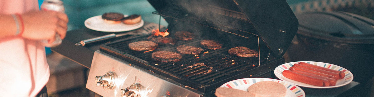 Man grilling hamburgers and hotdogs