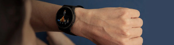 Closeup of a person wearing a black Garmin Venu 2 GPS watch.