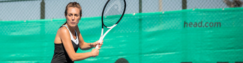 Image of a woman preparing to hit a tennis ball with a HEAD Speed 2022 tennis racquet.