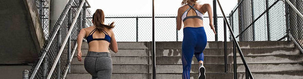 Women running up stairs in adidas running shoes and athletic apparel