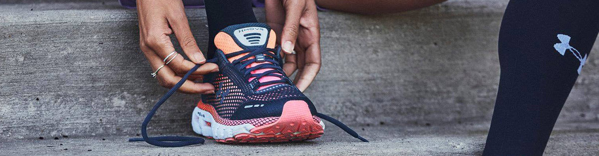 Woman in Under Armour women's HOVR Inifinite running shoes