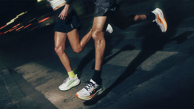 Two runners in motion at night wearing HOKA Clifton Pro running shoes