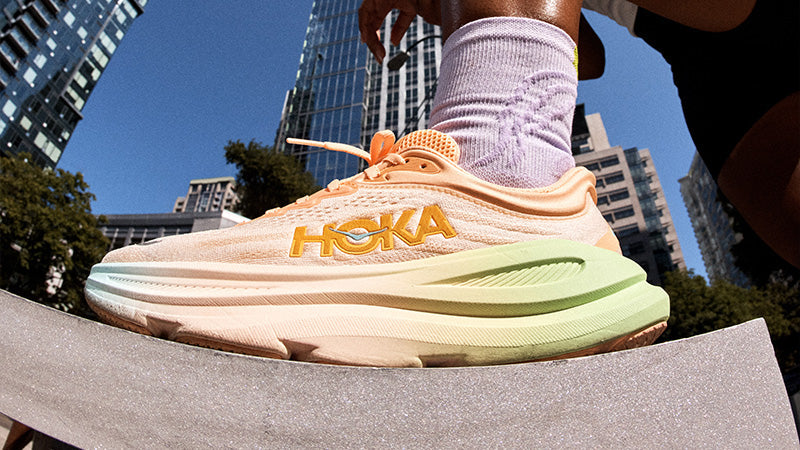 Hoka running shoe with cityscape in the background