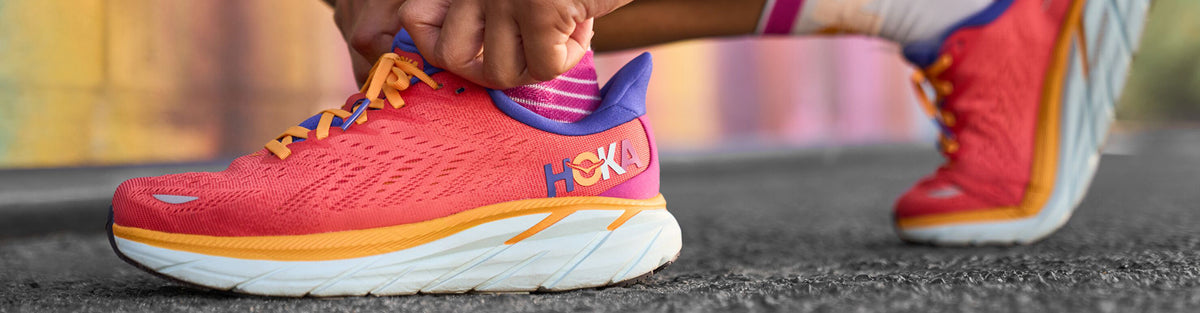 Woman wearing HOKA Clifton 8 Start Pack running shoes
