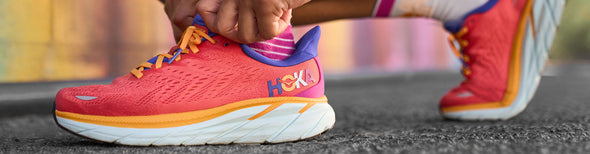 Woman wearing HOKA Clifton 8 Start Pack running shoes