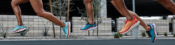 Men and women running in colorful HOKA Clifton 8 running shoes.