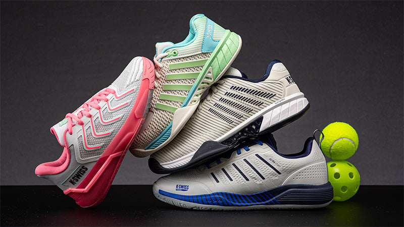 Four pairs of K-Swiss court shoes with tennis and pickleball balls on a dark background