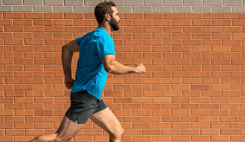 man running along brink wall