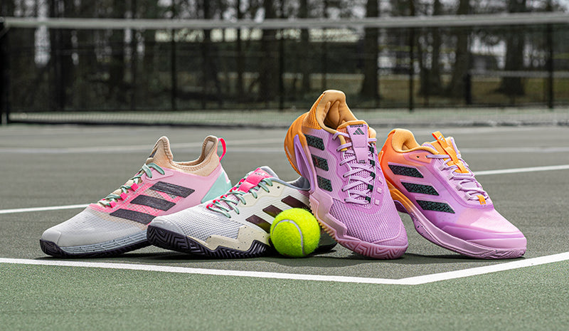 adidas tennis shoes on tennis court