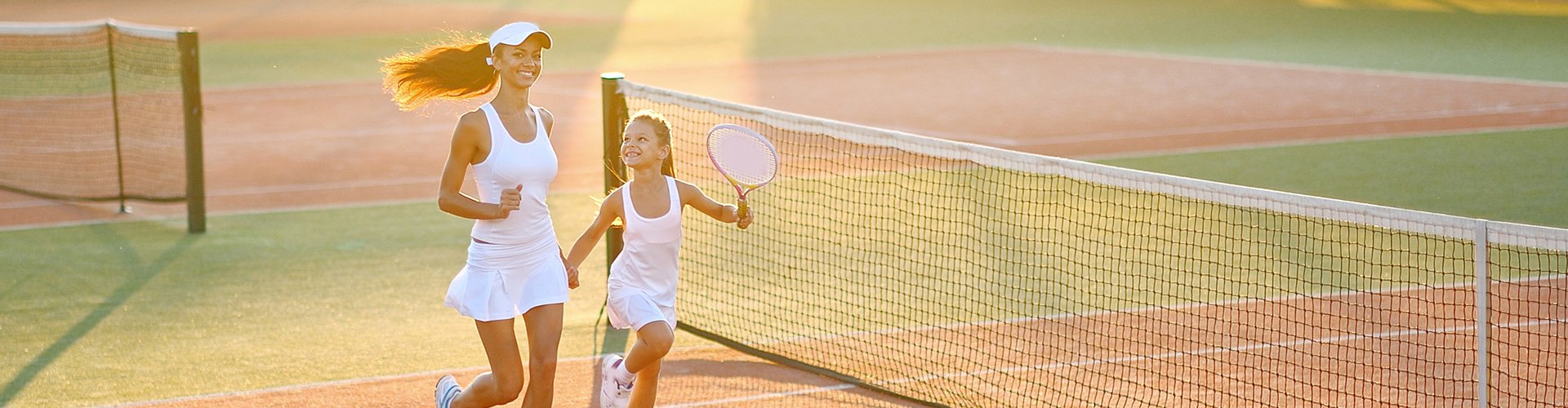 Woman and child on tennis court together