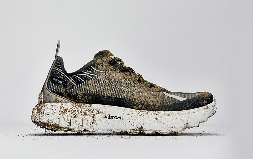 muddy norda trail shoe on gray background