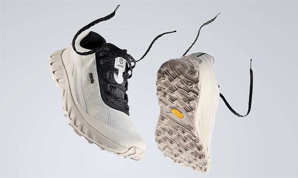 A person runing a dusty trail in norda 002 trail running shoes.