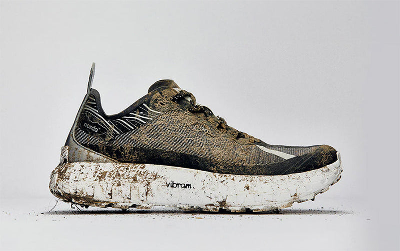 muddy norda trail shoe on gray background