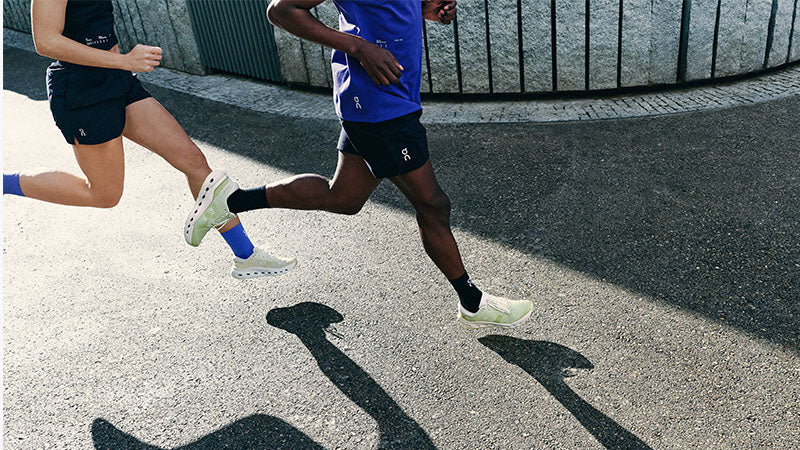 two people running a paved surface in On Cloudrunner 3 running shoes
