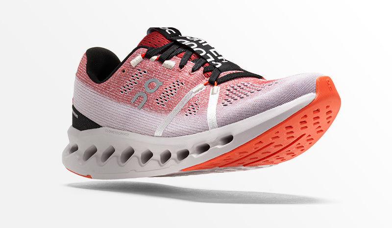 on cloudsurfer running shoes on white background