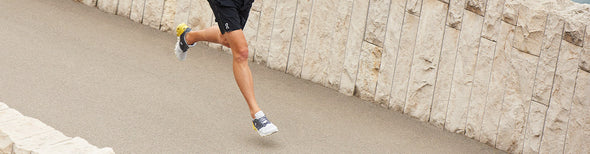 Man running in On Running running shoes and apparel