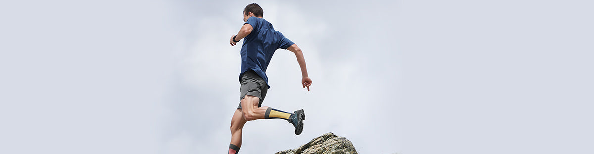 Man running outdoors in On Running running shoes and athletic apparle