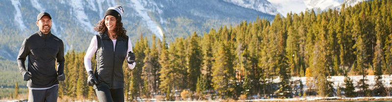 Man and woman running in winter running apparel outside