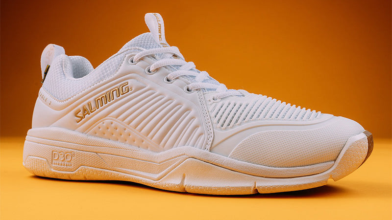 White Salming Eagle 2 squash shoes against an orange backdrop