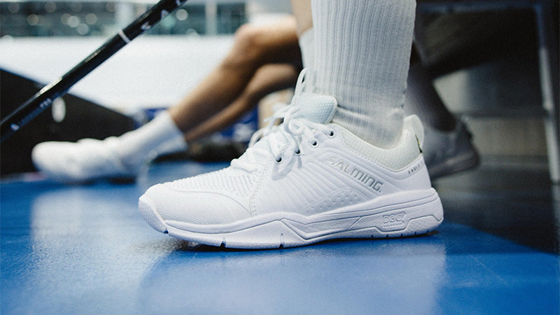 person wearing white Salming Eagle 2 indoor court shoes