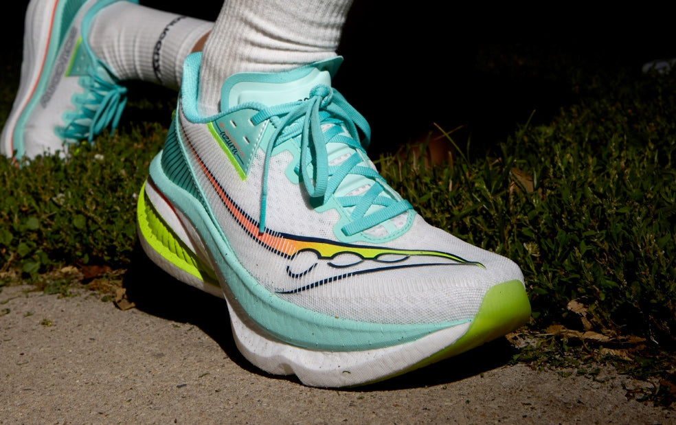 People running at night wearing Saucony Endorphin Azura running shoes