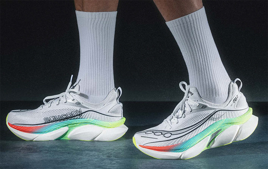 Person running on pavement at night wearing Saucony Endorphin Elite 2 running shoes