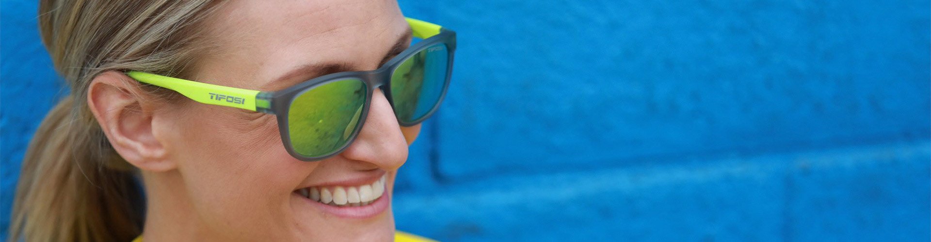 Woman wearing lime green Tifosi sunglasses