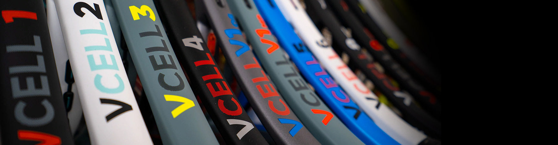 Close up view of the the Volkl V-Cell family of tennis racquets sitting in a row.