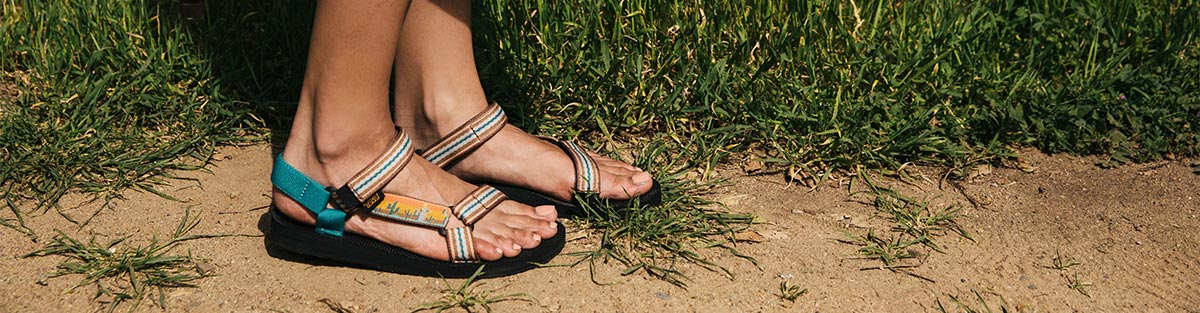 Woman wearing Teva sandals by the beach