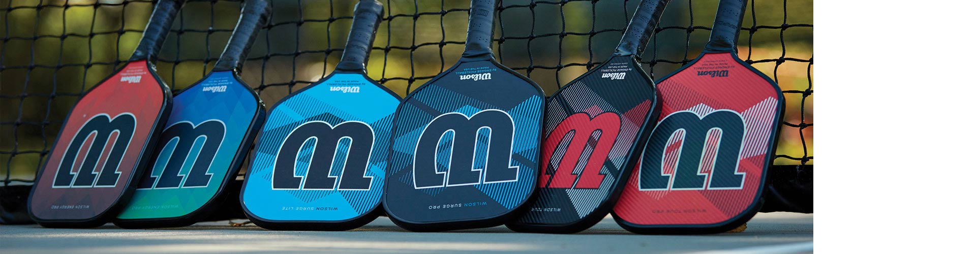 Woman swinging Wilson tennis racquet on court