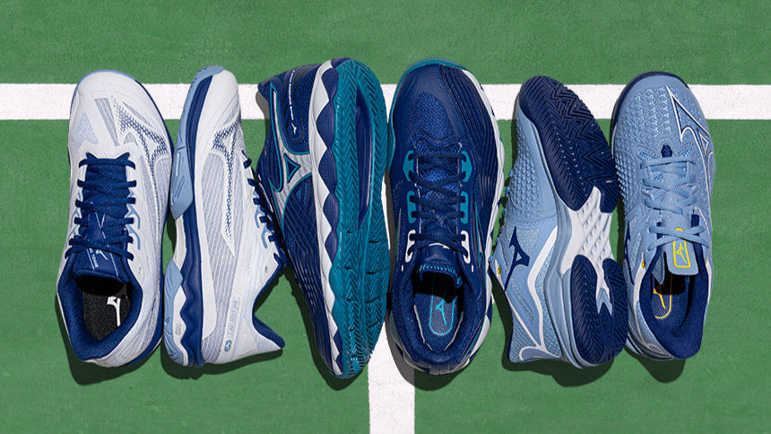 Mizuno tennis shoes on a green court