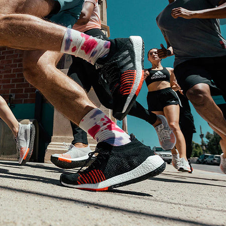 Close up of shoes, group running on pavement