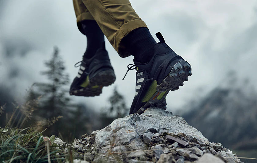 hiking with black adidas shoes