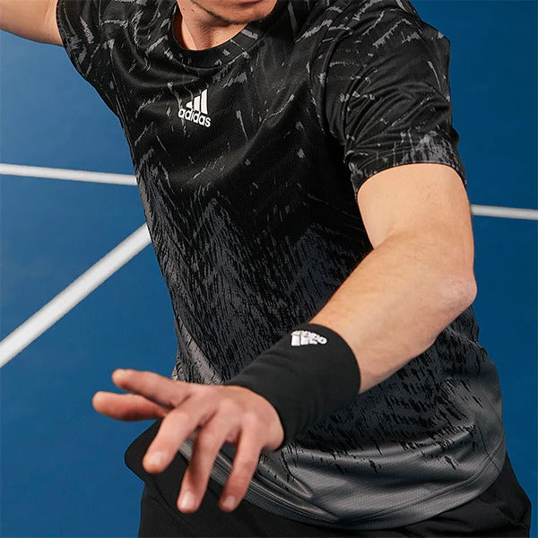 Man wearing black-grey pattern Adidas tennis shirt