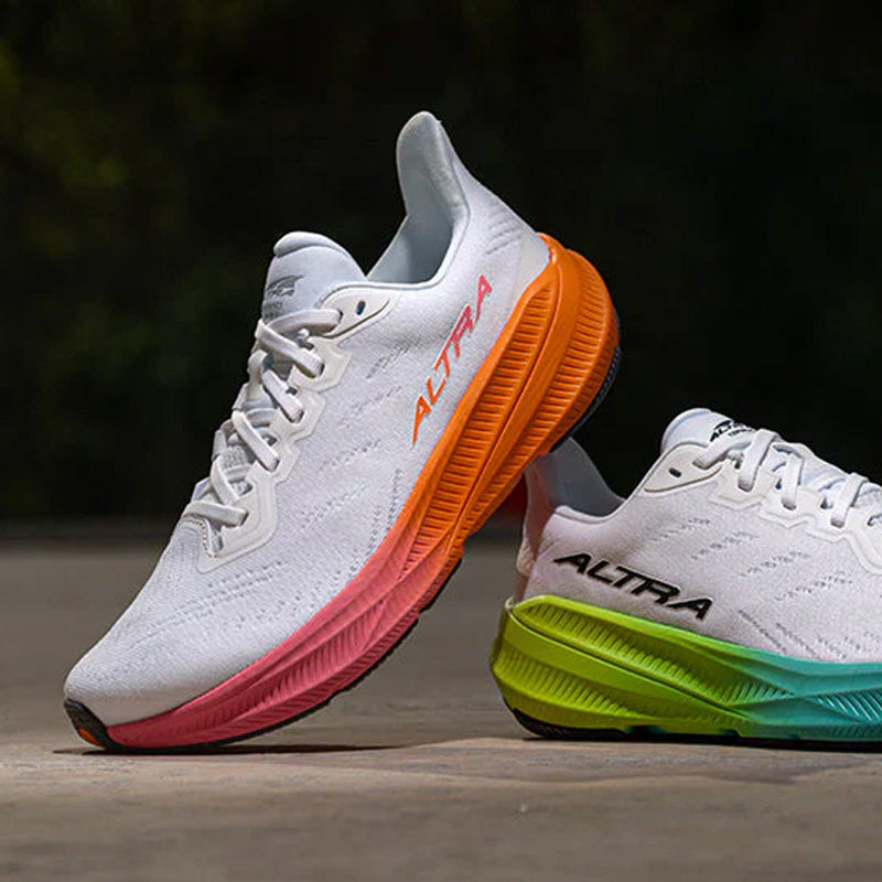 White Altra Experience Flow 2 running shoes with a pink and orange midsole