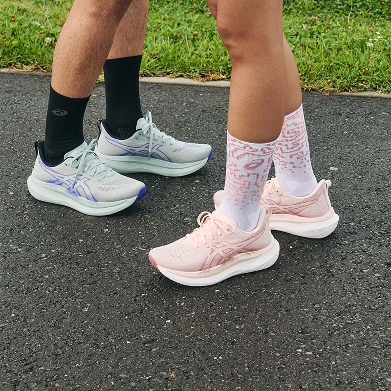 People standing on a blacktop surface in ASICS Glideride Max 2 running shoes