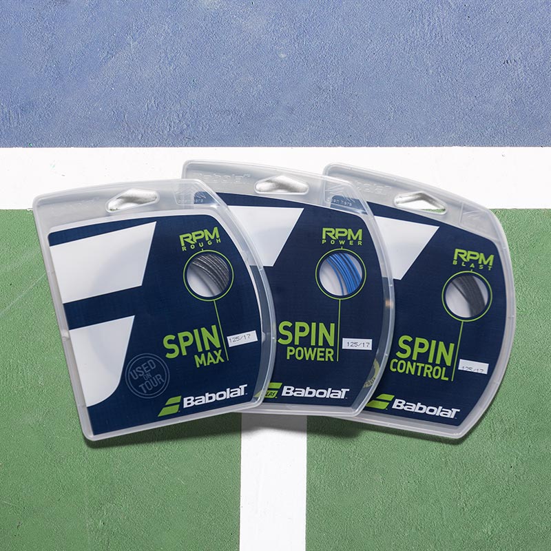 Babolat RPM tennis string sets on a blue and green tennis court.