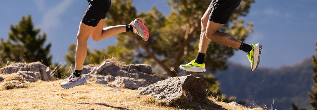 Man and woman running on hill