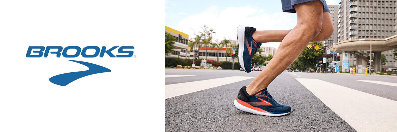 A man running down a city street with buildings in the background, wearing the Brooks Ghost 16 running shoes.