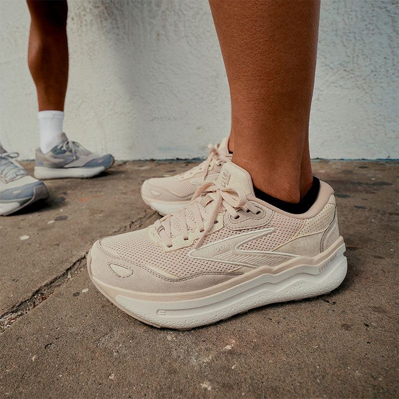 Two people standing on a sidewalk in Brooks Ghost Max SE walking shoes