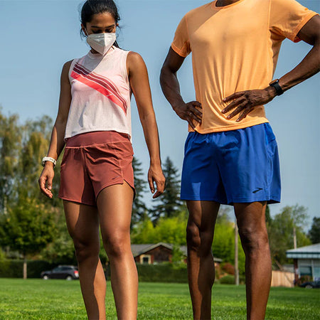 Brooks Woman and Man standing on Glass