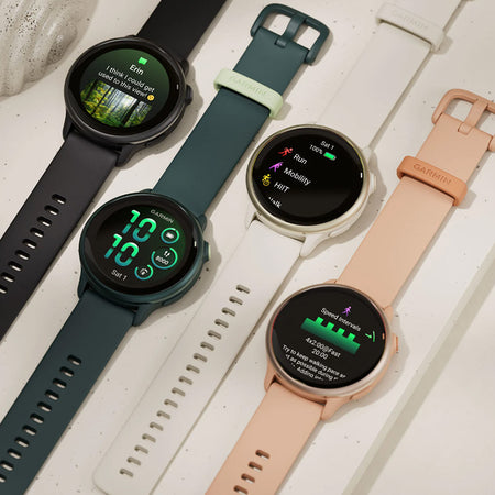 Four Garmin vivoactive 6 GPS watches with different colored bands on a light surface