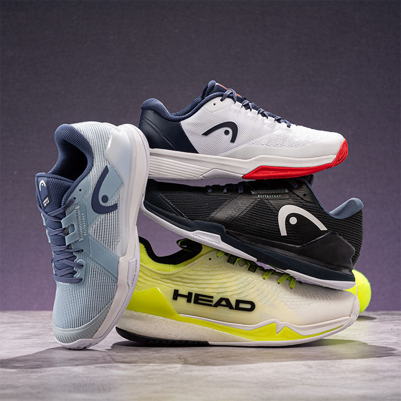 Stack of HEAD tennis shoes on a gray background