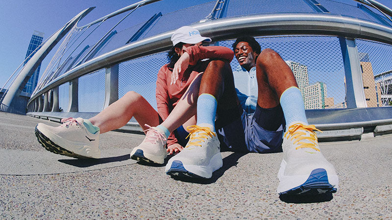 runners sitting together and wearing hoka arahi 8 running shoes