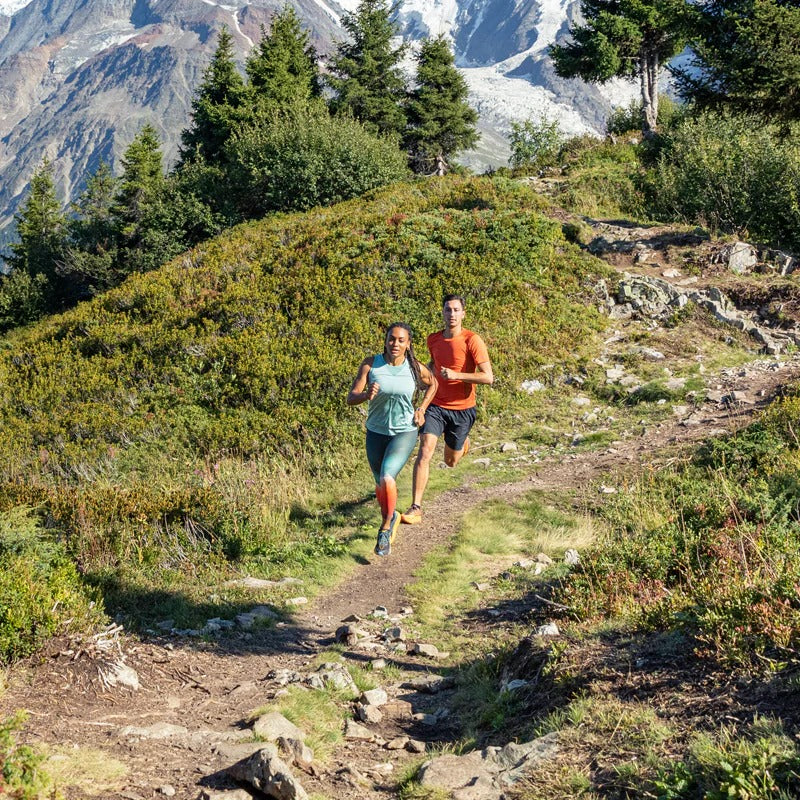men and woman running in nature