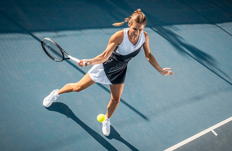 A person about to use a HEAD Speed 2026 tennis racquet to return a yellow ball on a blue tennis court.