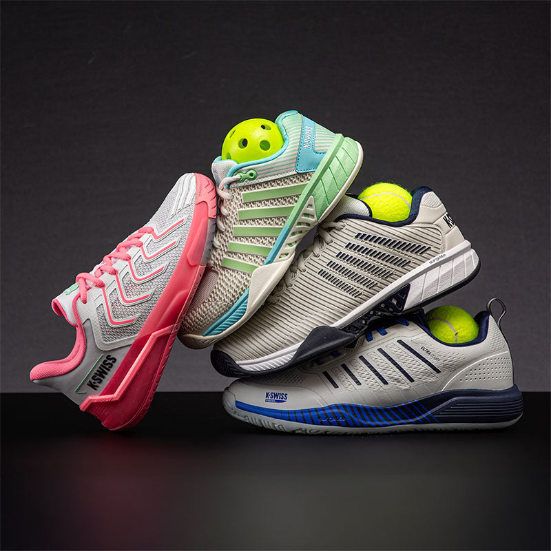 Four pairs of K-Swiss court shoes with tennis and pickleball balls on a dark background