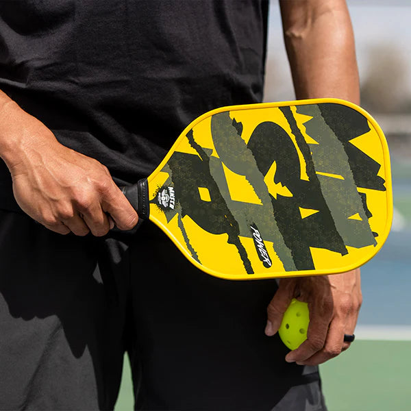 Man holding pickle ball paddle