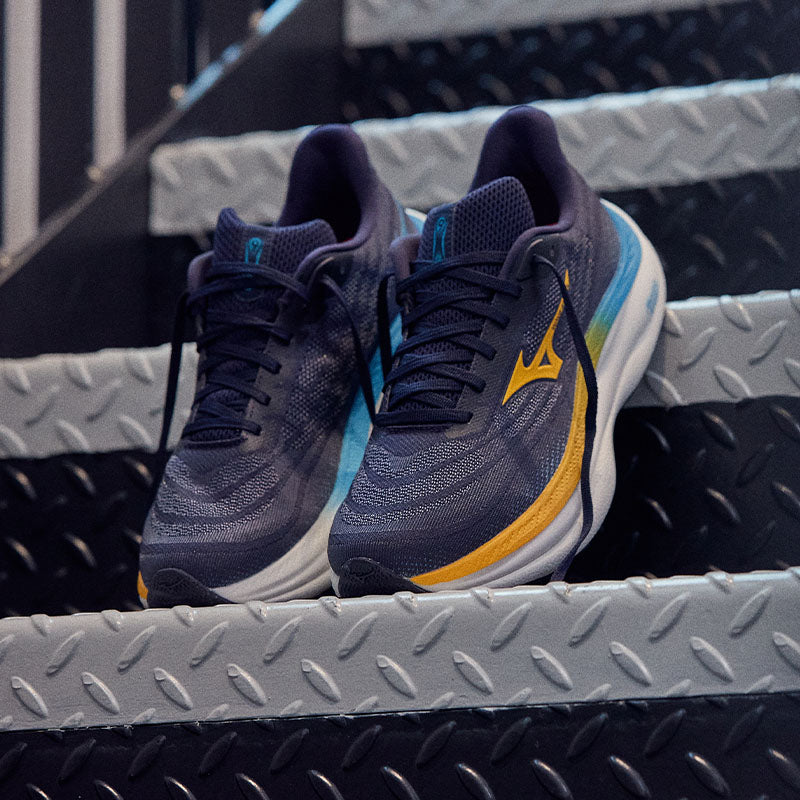 Pair of Mizuno Wave Sky 9 running shoes on a set of diamond plate stairs