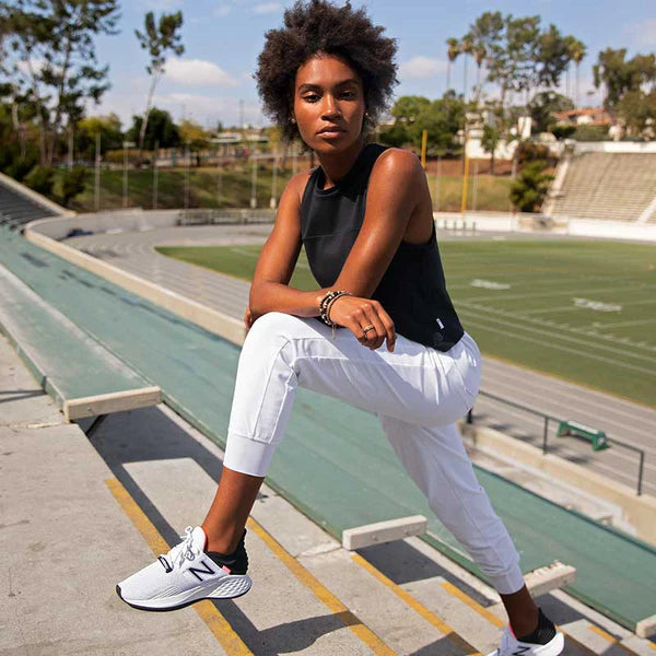 Woman with white new balance shoes stretching